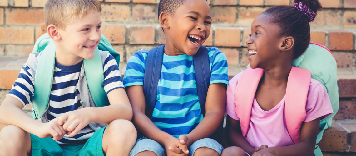 Three children happy at school.